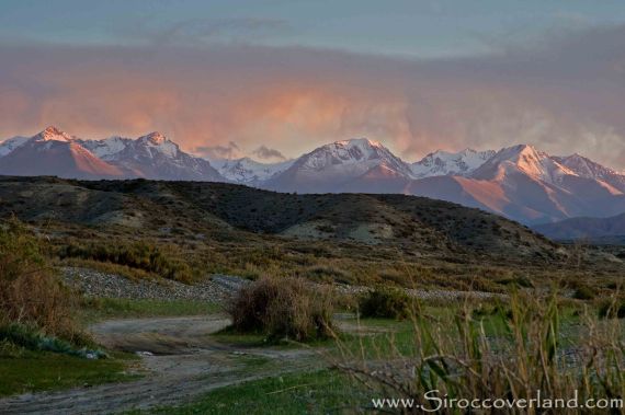 Sunset lighting up the Tien Shan from Issyk-kol Lake, Kyrgyzstan